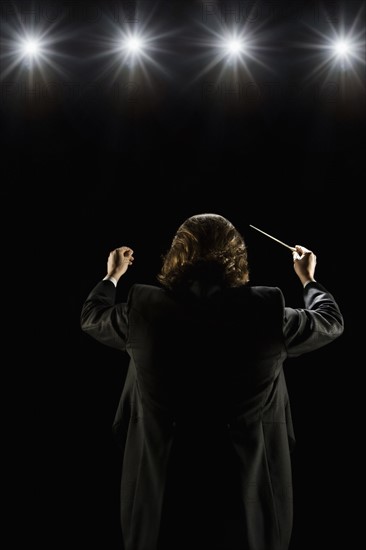 Man conducting under lights. Date : 2008