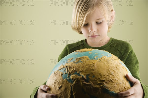 Boy hugging globe. Date : 2008