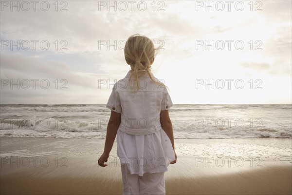 Girl looking out at ocean. Date : 2008