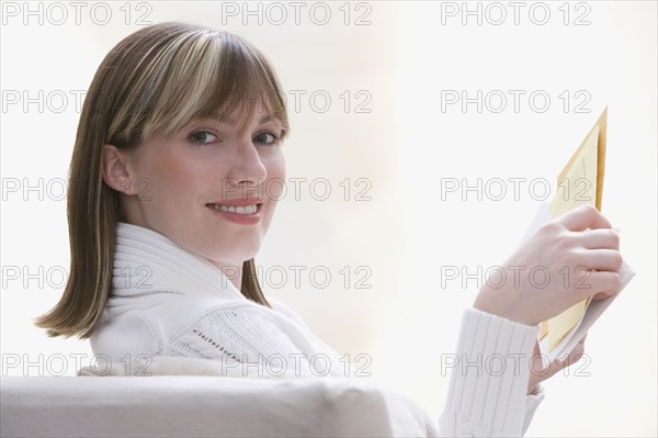 Woman holding mail. Date : 2008
