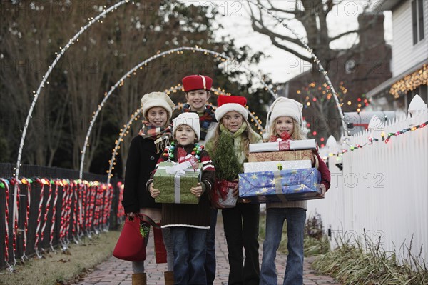 Children holding Christmas gifts. Date : 2008