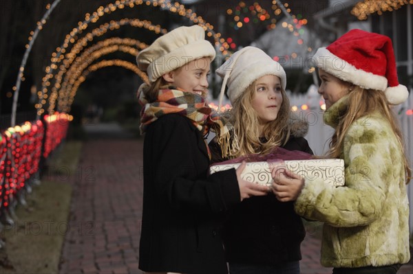 Girls holding Christmas gift. Date : 2008