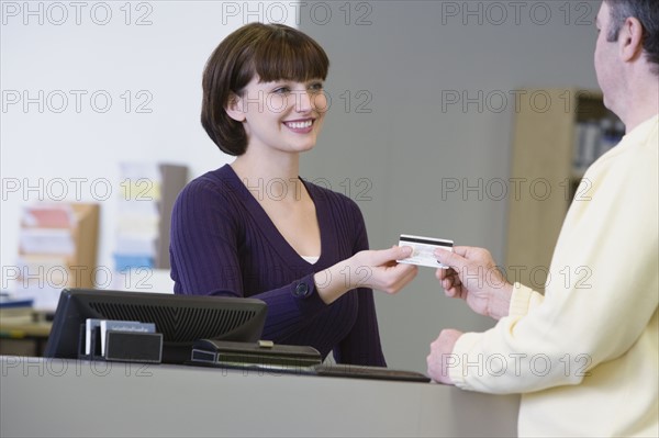 Receptionist accepting payment. Date : 2008