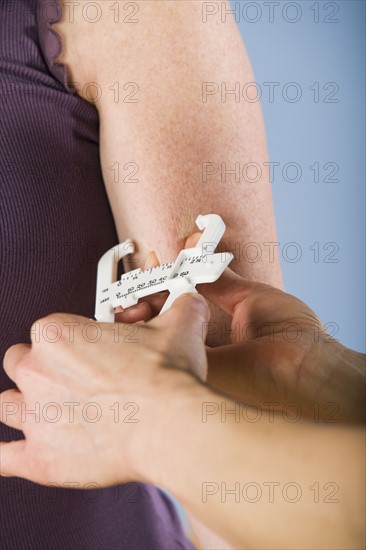 Trainer measuring body fat percentage. Date : 2008