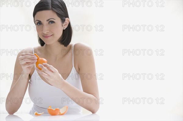 Woman peeling orange. Date : 2008