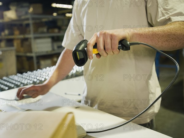 Warehouse worker scanning package. Date : 2008