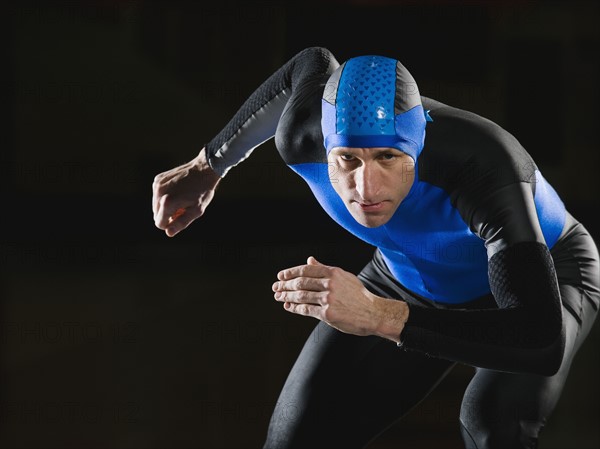 Male speed skater in ready position. Date : 2008