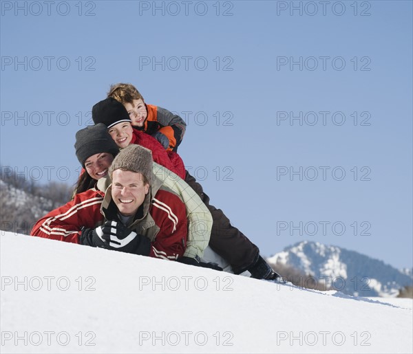 Family laying in snow. Date : 2008