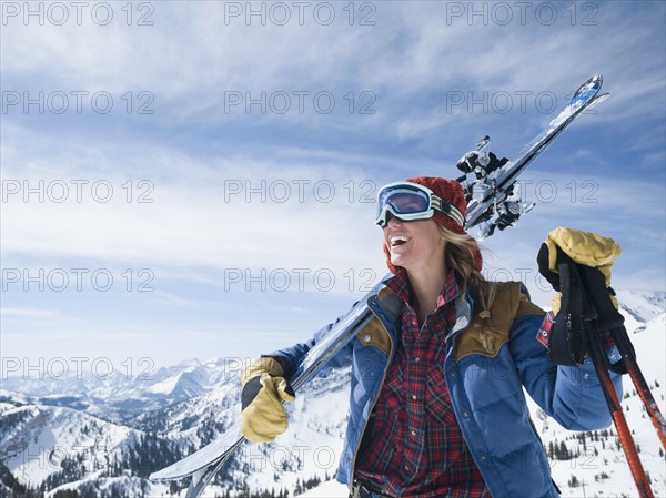 Woman holding skis on shoulder. Date : 2008