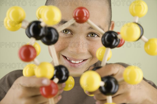 Boy holding molecular model. Date : 2008