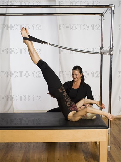 Woman exercising on pilates equipment. Date : 2008