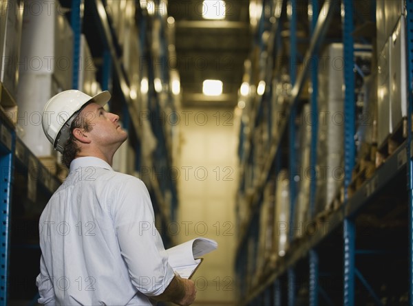 Warehouse worker checking inventory. Date : 2008