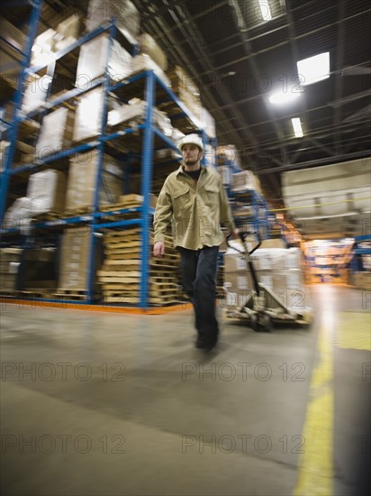 Warehouse worker pulling palette. Date : 2008