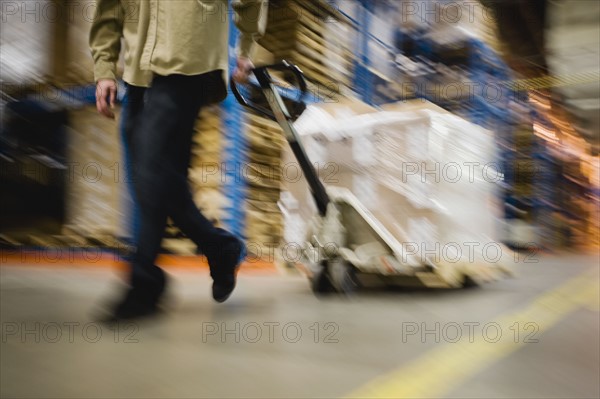 Warehouse worker pulling palette. Date : 2008