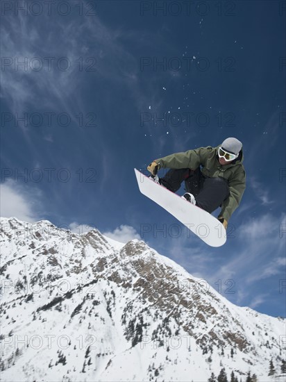 Man on snowboard in air, Wasatch Mountains, Utah, United States. Date : 2008