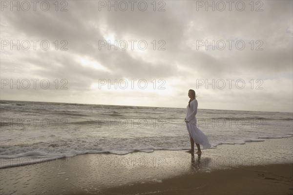 Woman standing in ocean surf. Date : 2008