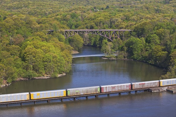 Cargo train on rail over river, New York, United States. Date : 2008
