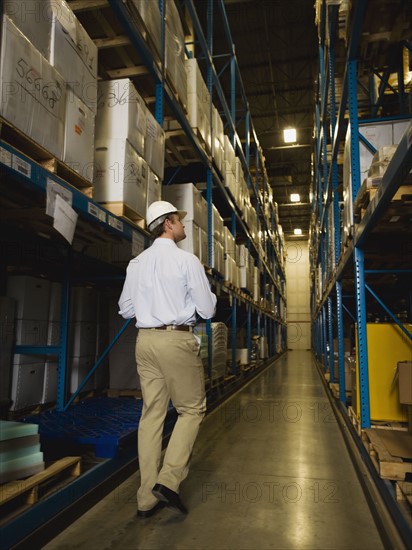 Warehouse worker checking inventory. Date : 2008