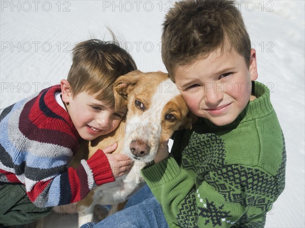 Brothers hugging dog. Date : 2008