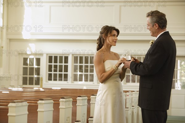 Bride and groom smiling at each other. Date : 2008