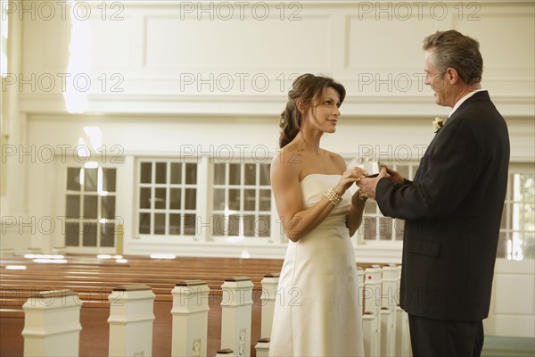 Bride and groom smiling at each other. Date : 2008
