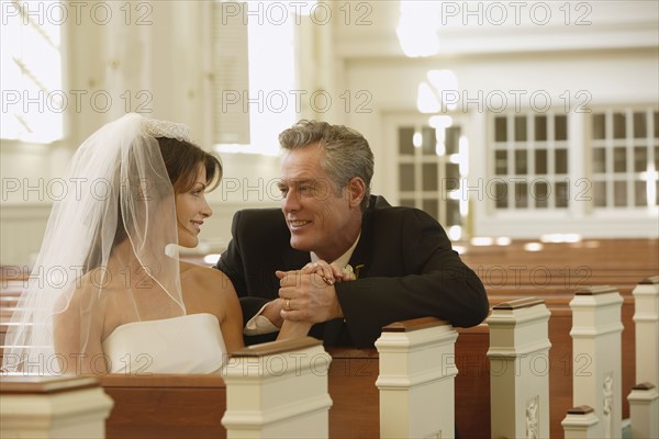 Bride and father smiling at each other. Date : 2008