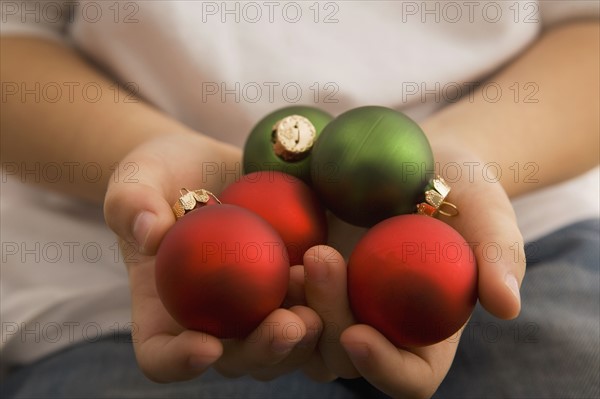 Boy holding Christmas ornaments. Date : 2008