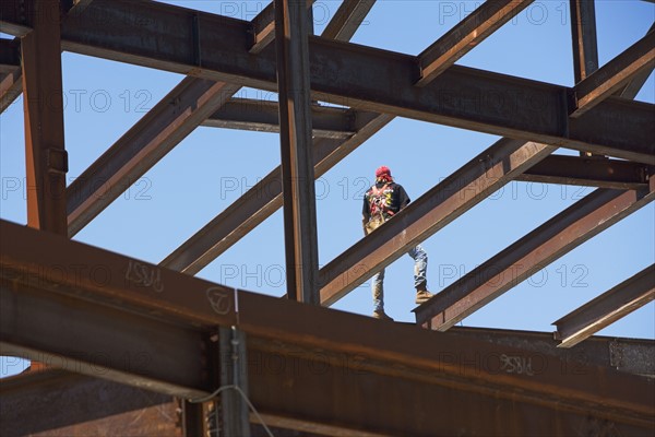 Construction worker on steel beam at construction site. Date : 2008