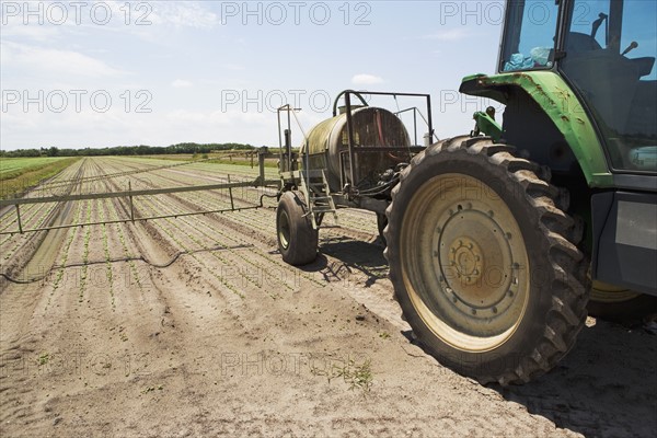 Tractor spraying field, Florida, United States. Date : 2008