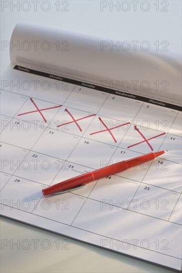 Close up calendar with days marked off.