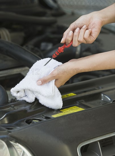 Mechanic checking oil.