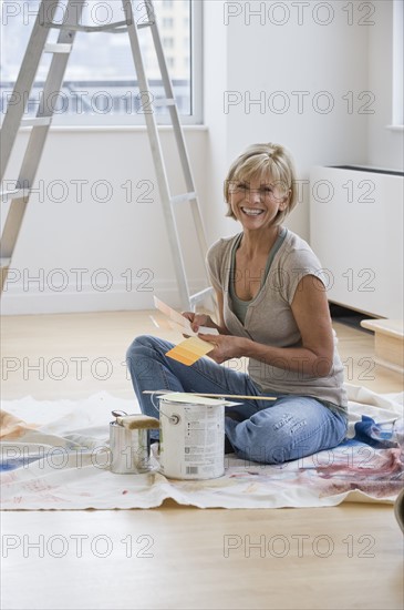 Woman painting room.