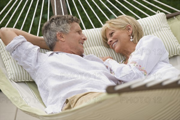 Couple relaxing in hammock.
