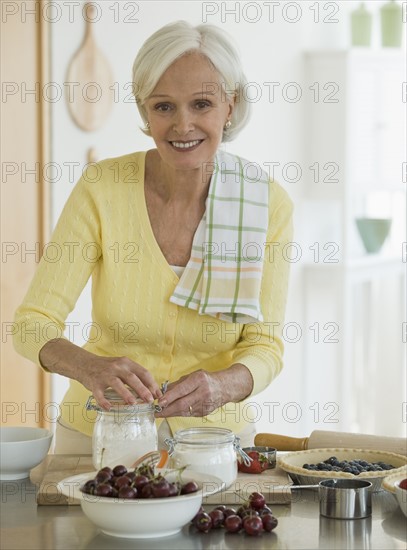 Senior woman making pies.