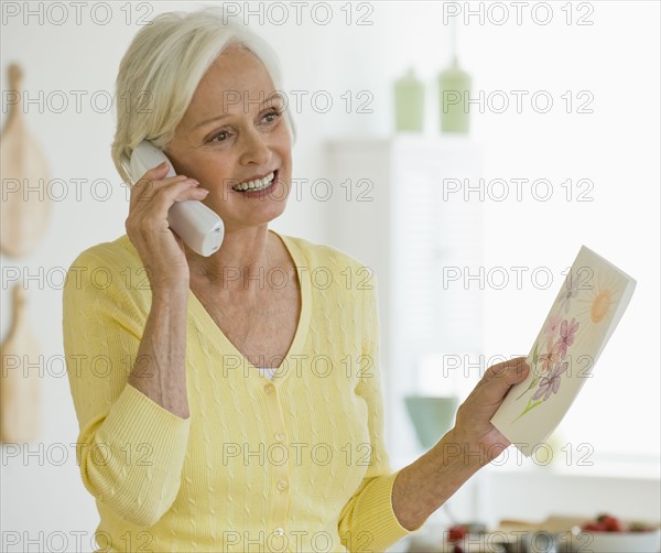Woman talking on telephone.