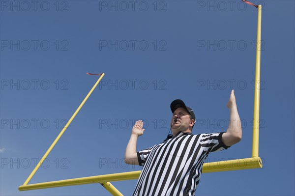 Football referee calling field goal.