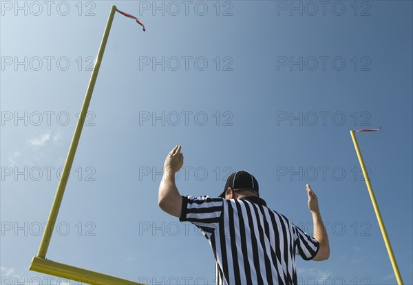 Football referee calling field goal.