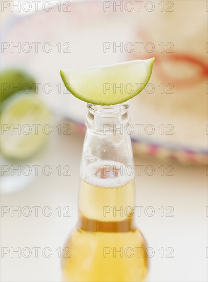 Close up of lime balancing on beer bottle. Date : 2008