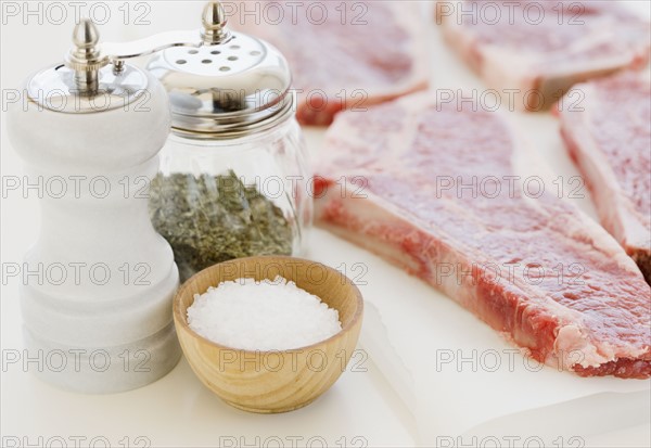 Close up of raw steaks and seasoning. Date : 2008