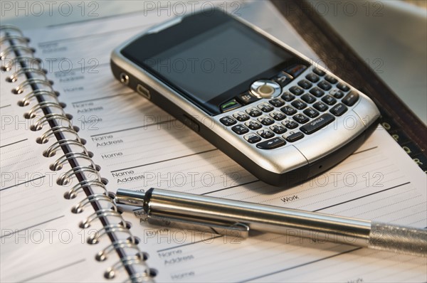 Close up of cell phone and address book. Date : 2008