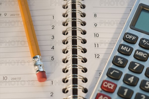 Close up of pencil, notebook and calculator. Date : 2008