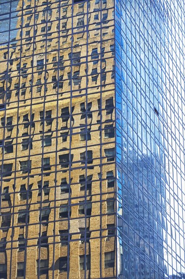 Old building reflected in modern building windows. Date : 2008