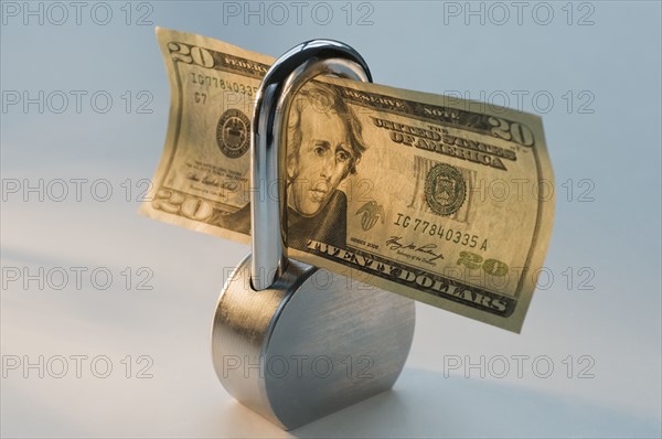Close up lock and dollar bill. Date : 2008