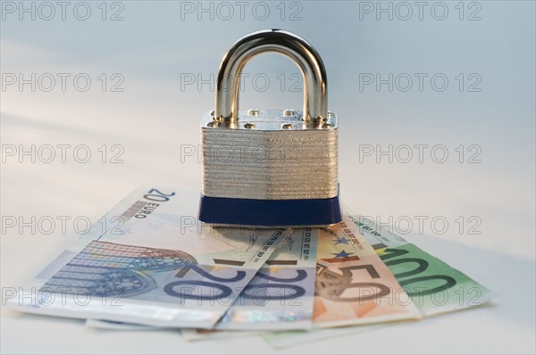 Close up lock and paper euros. Date : 2008