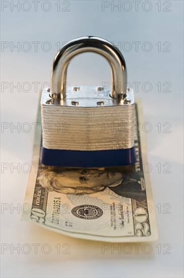 Close up lock and twenty dollar bill. Date : 2008