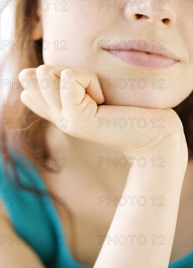 Close up of teenage girl resting head in hand. Date : 2008