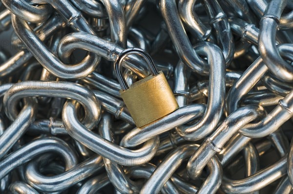 Close up of lock on pile of metal chain. Date : 2008