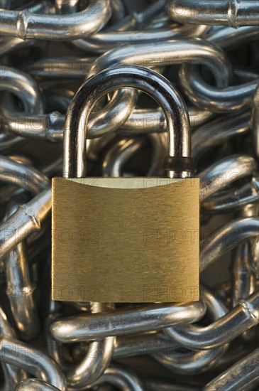 Close up of lock on pile of metal chain. Date : 2008