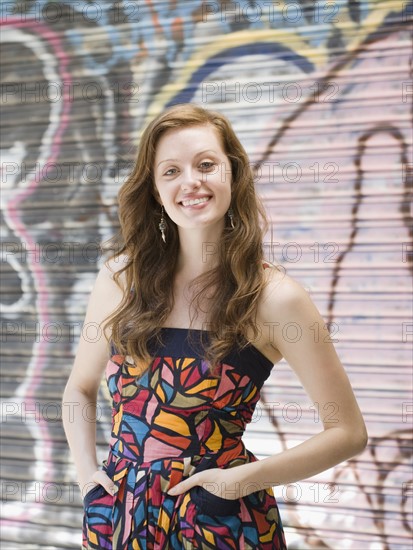 Young woman standing in front of graffiti. Date : 2008