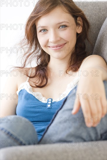 Teenage girl relaxing on arm chair. Date : 2008